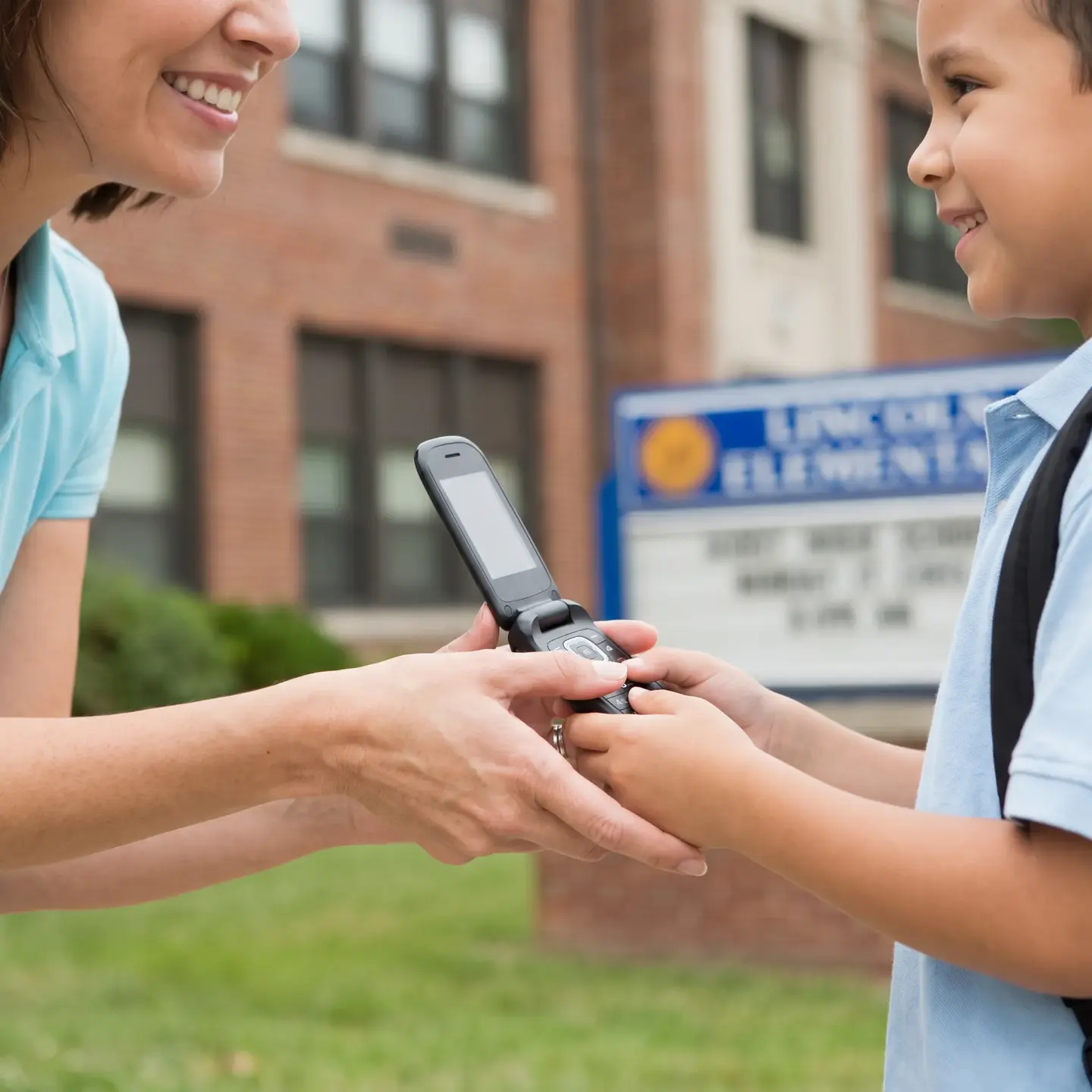 Mother handing basic phone to child